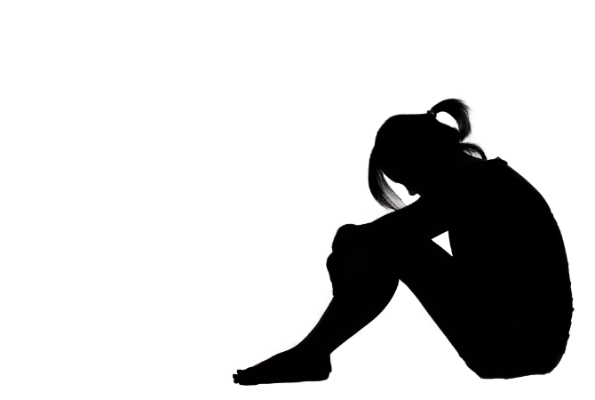 Profil af et ungt menneske der sidder på gulvet med bøjet nakke.